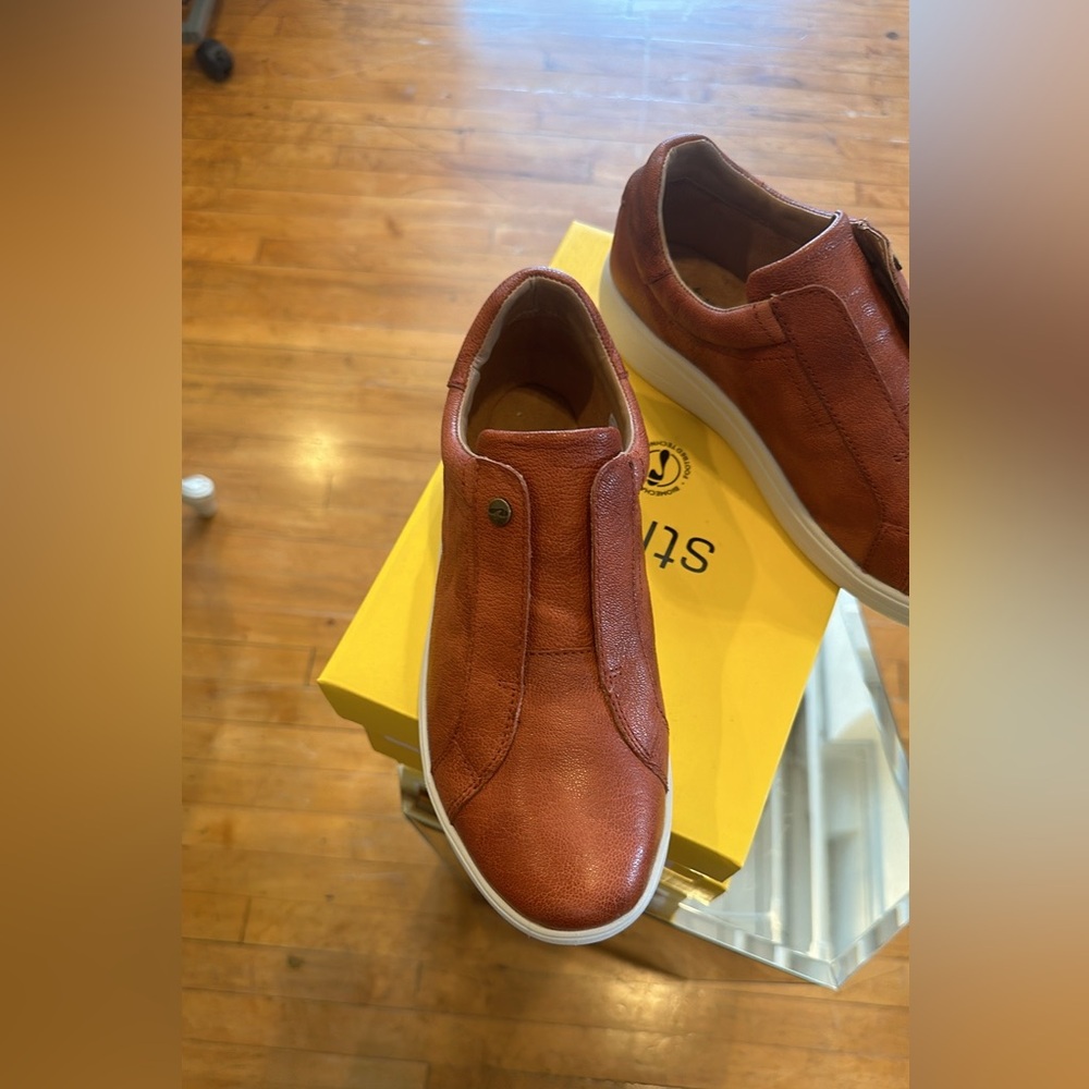 Orange leather low cut shoes.